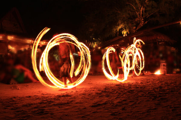 Three Strong Men Juggling Fire Dancing on the Sairee Beach Thailand